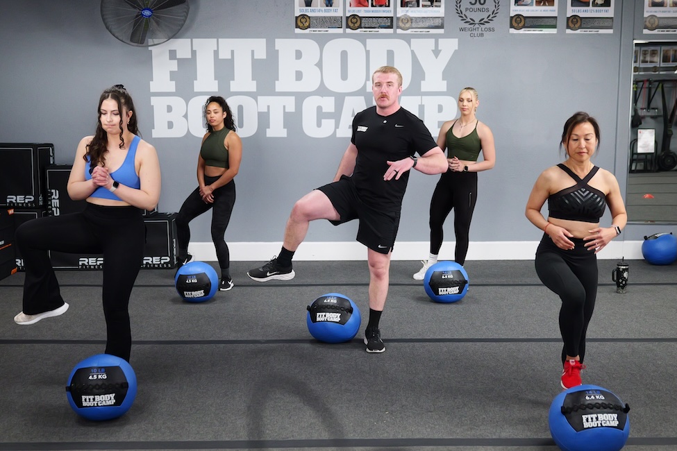 Group of people working out at Fit Body Boot Camp with exercise balls